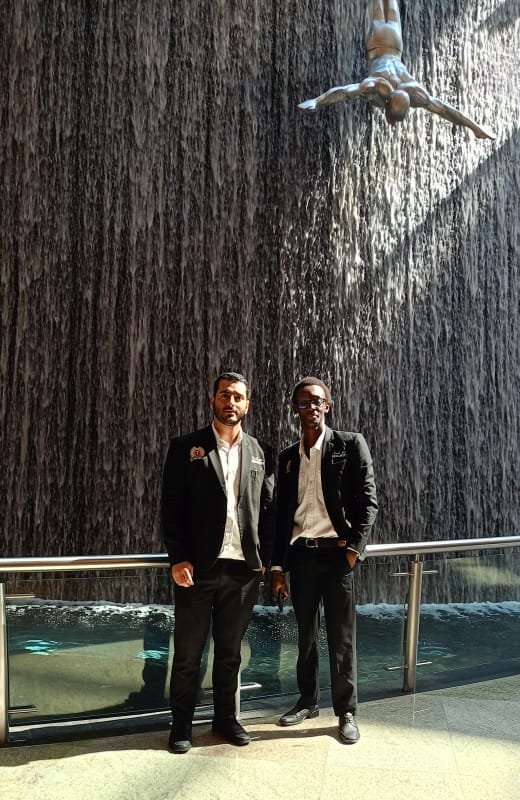 Eric N. Gitau (right) at the Dubai Mall waterfall